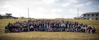 formal group photo of over 200 Harpers