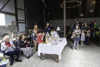 A number of Harper's gathered in shed around the art display of Nigel and Kyria Smith.